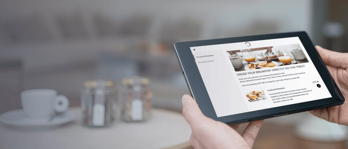 Hand holding SuitePad  Upsell 700x300