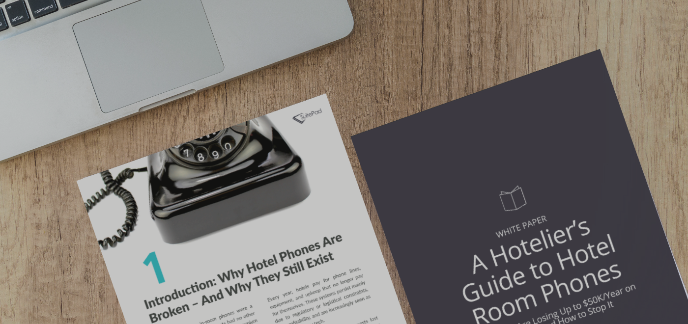 The Hotelier's Guide to Hotel Room Phones white paper mock up on a table next to a laptop