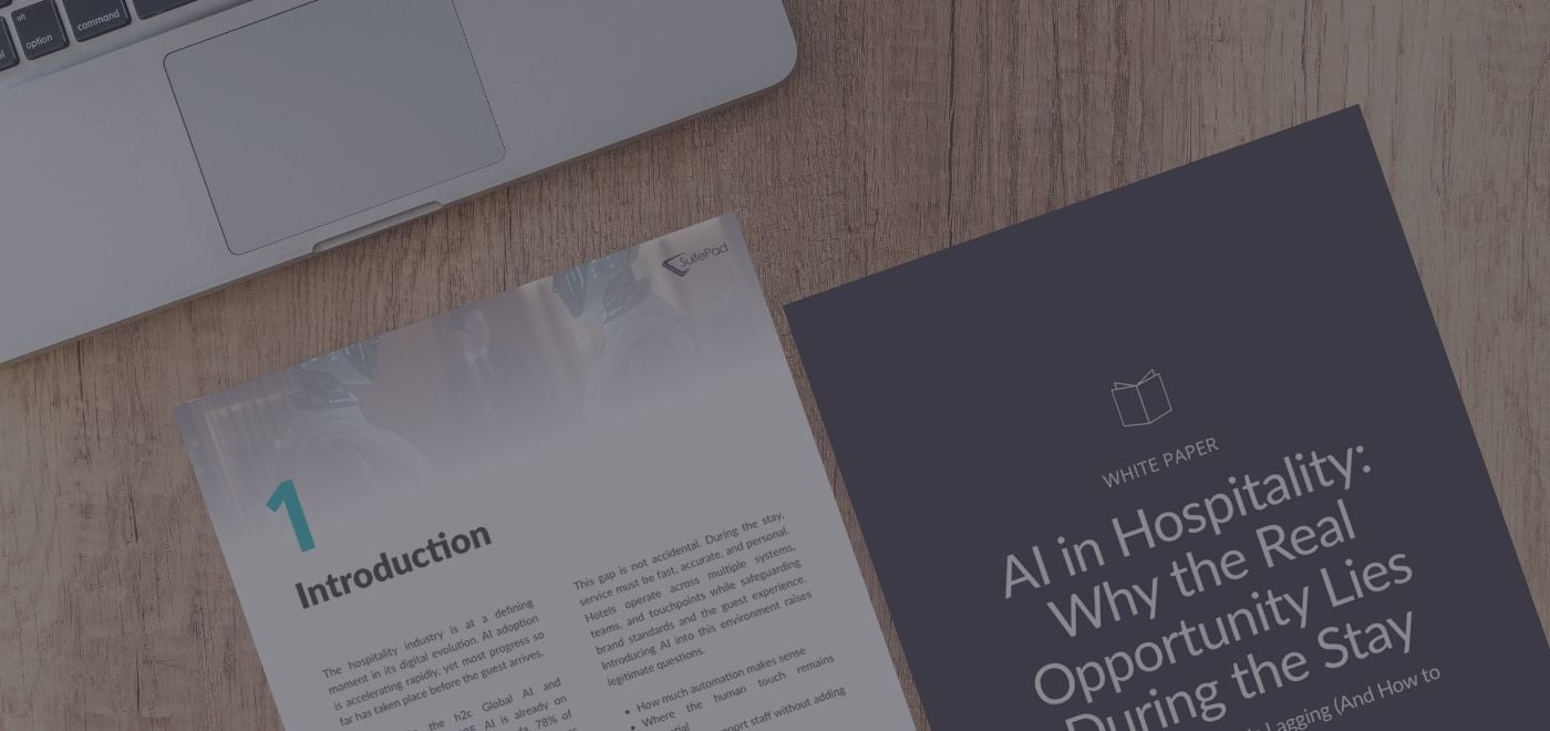 a mock up of the white paper pages on a table next to a grey laptop