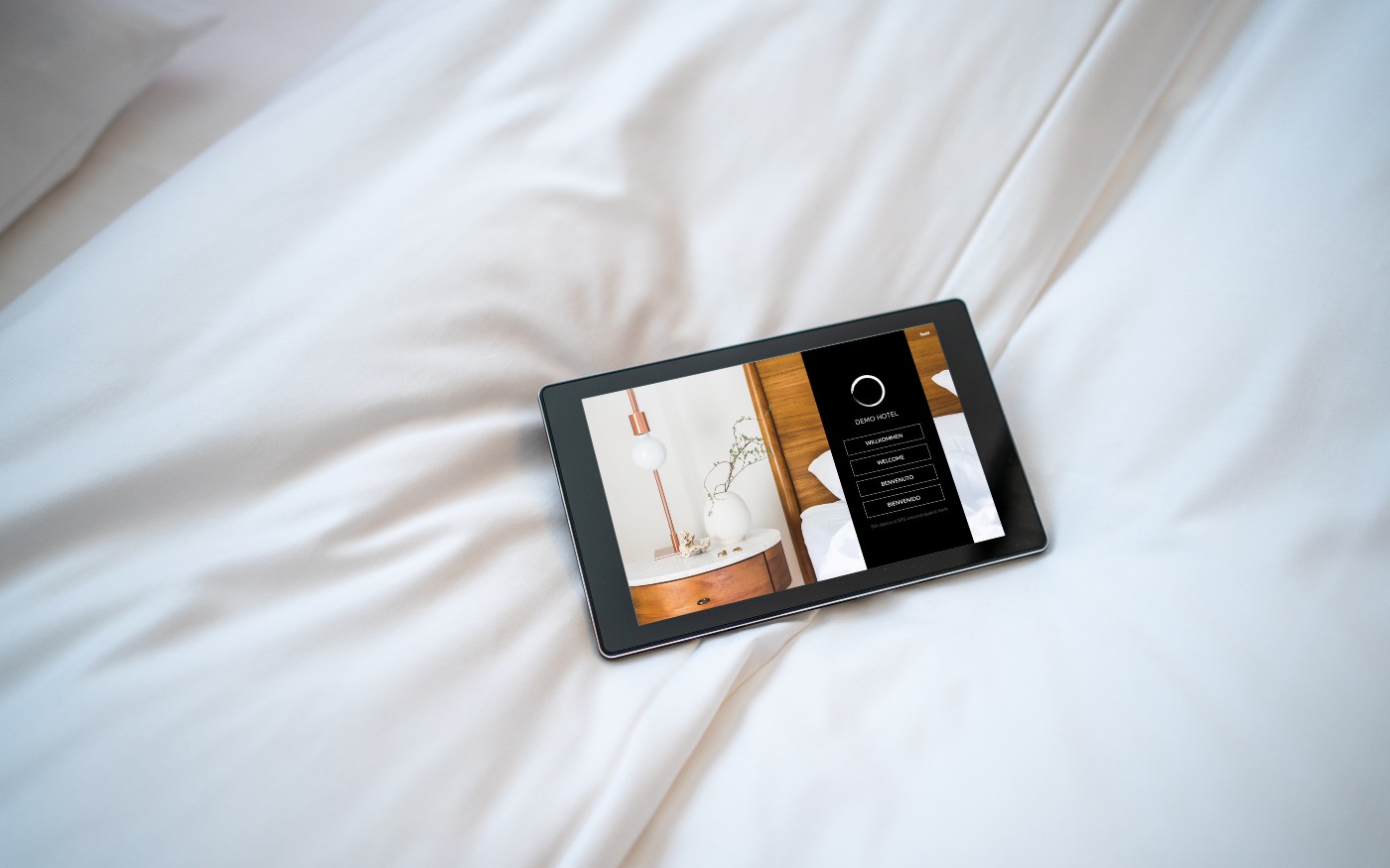 SuitePad tablet on a hotel bed
