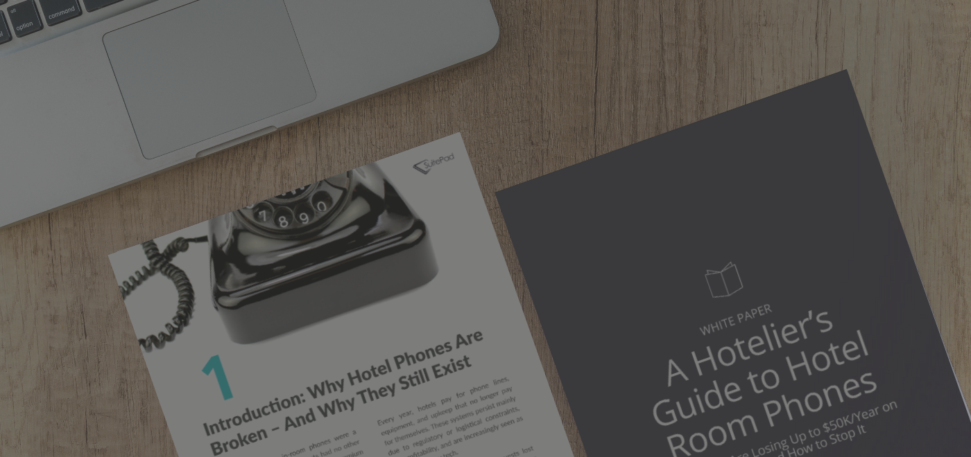 a mock up of the white paper pages on a table next to a grey laptop