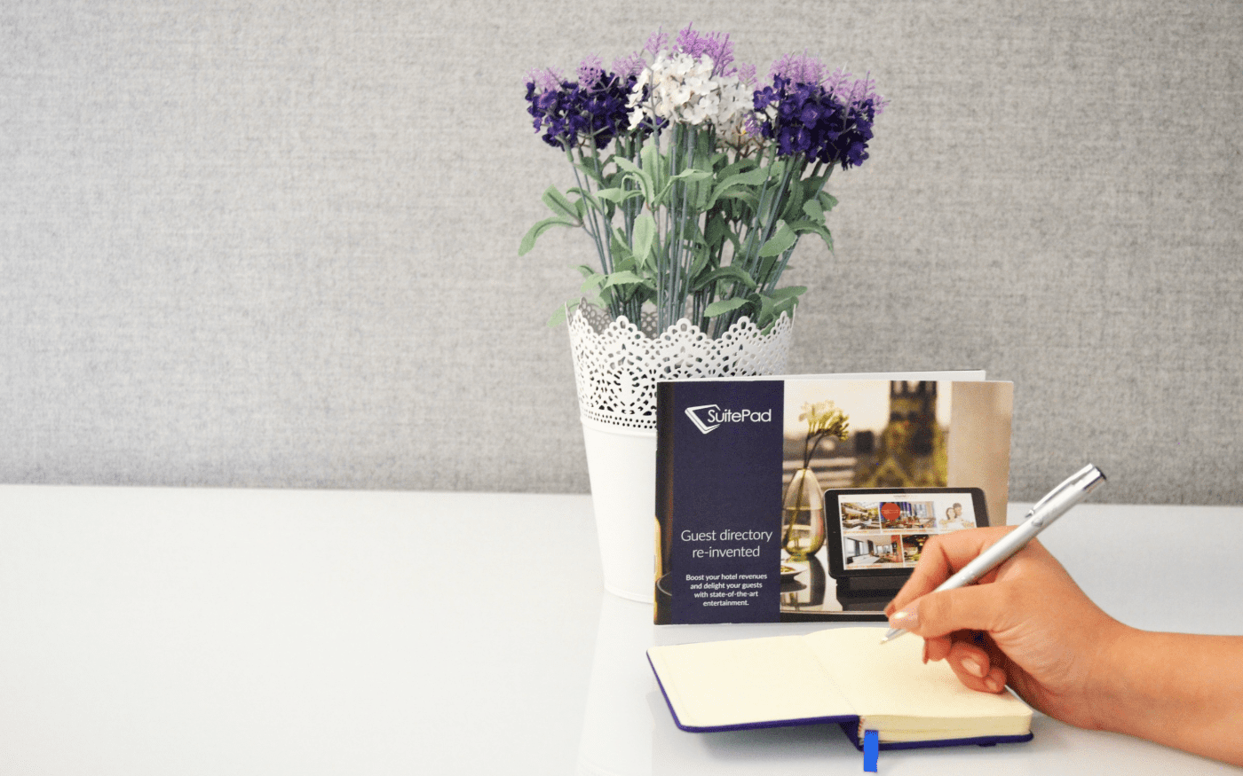 SuitePad brochure with a plant and a notebook
